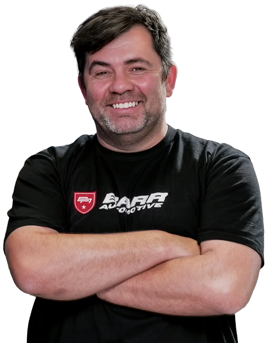 Igor S. of Barr Automotive standing with his arms folded
