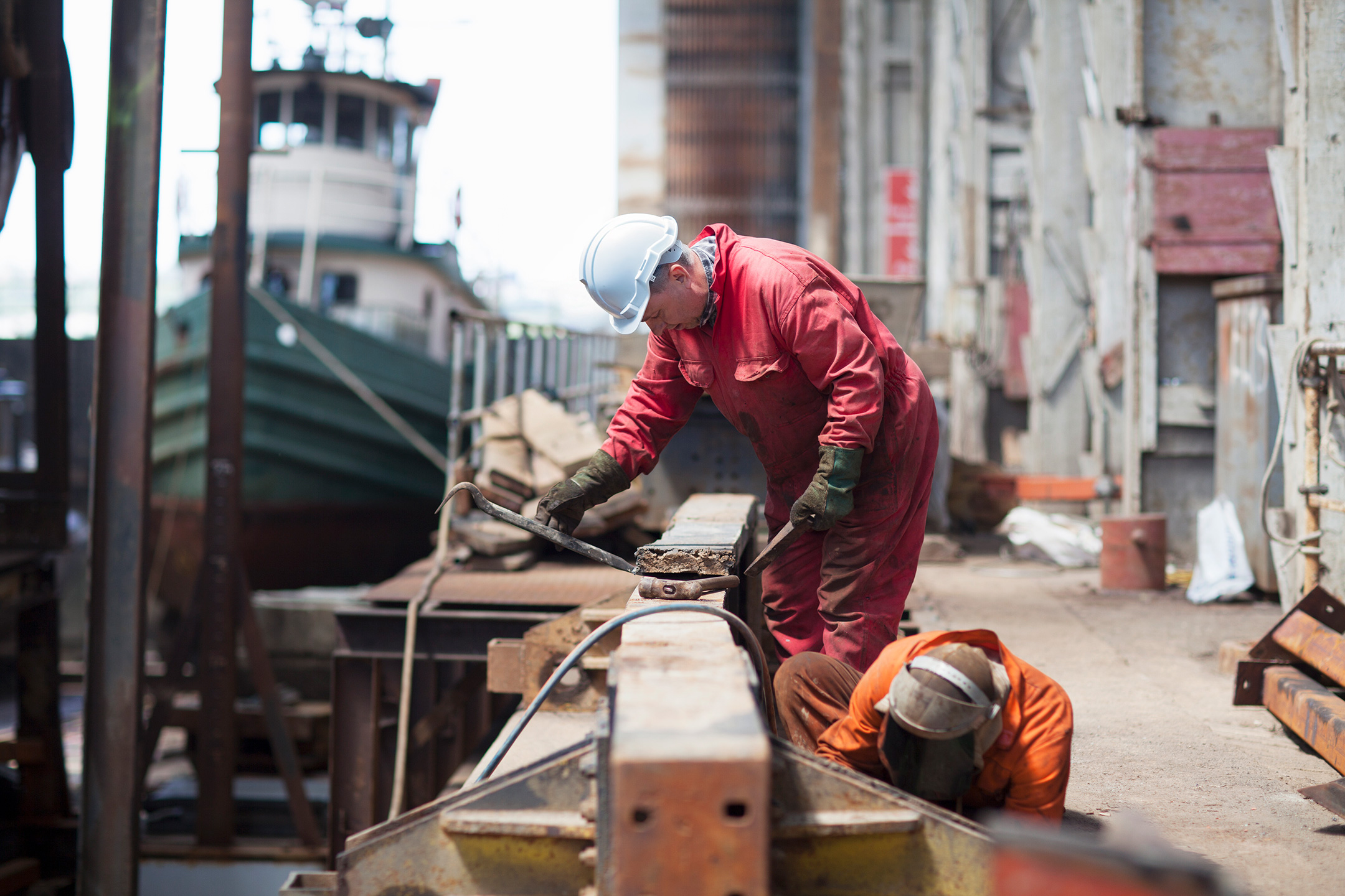 Workers engaged in shipyard maintenance